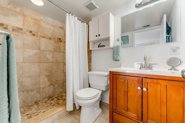 a bathroom with a toilet sink and shower