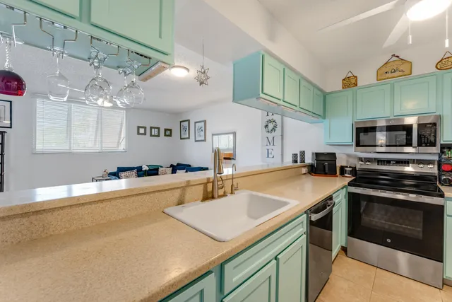 a kitchen with stainless steel appliances granite countertop a sink and a stove