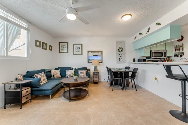 a living room with furniture and a dining table