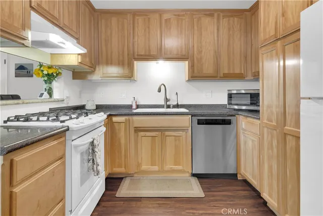 a large bedroom with a bed and wooden floor