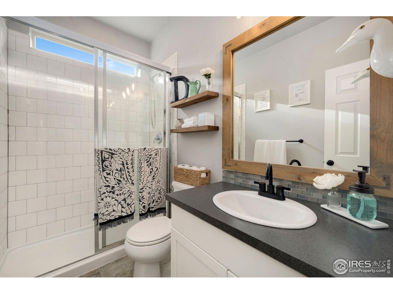 6420 Tuxedo Park Road Timnath, CO 80547 - Photo 11 of 44 a bathroom with a sink a toilet and shower