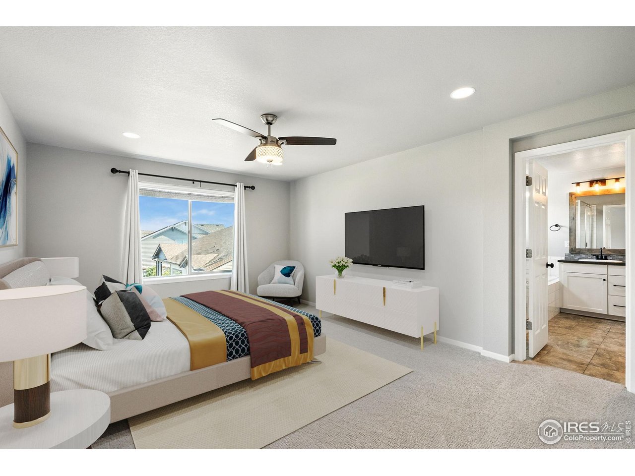6420 Tuxedo Park Road Timnath, CO 80547 - Photo 13 of 44 a bedroom with bed and a flat screen tv