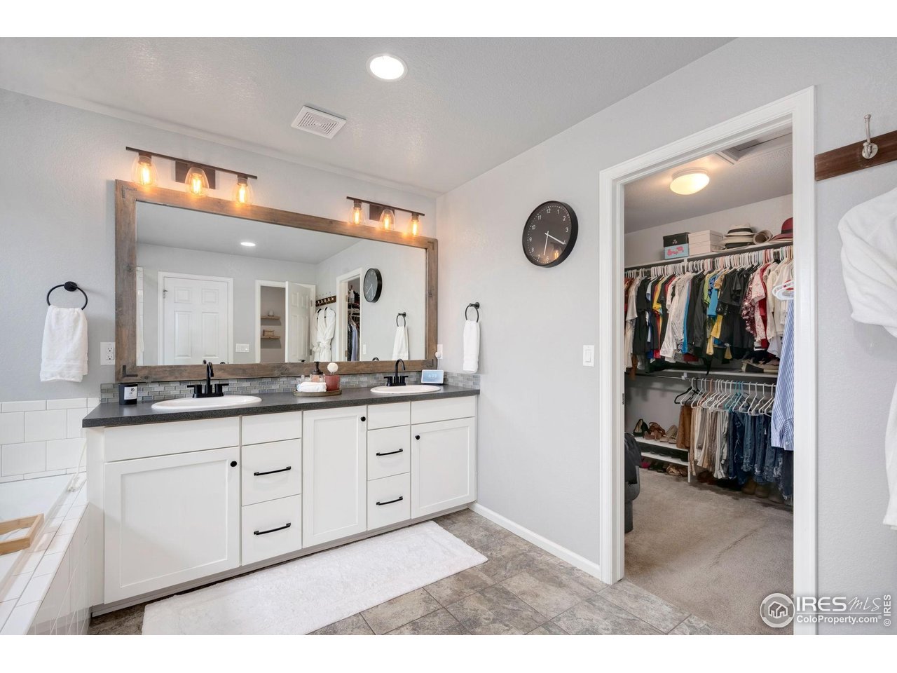 6420 Tuxedo Park Road Timnath, CO 80547 - Photo 17 of 44 a bathroom with a sink a vanity and a mirror