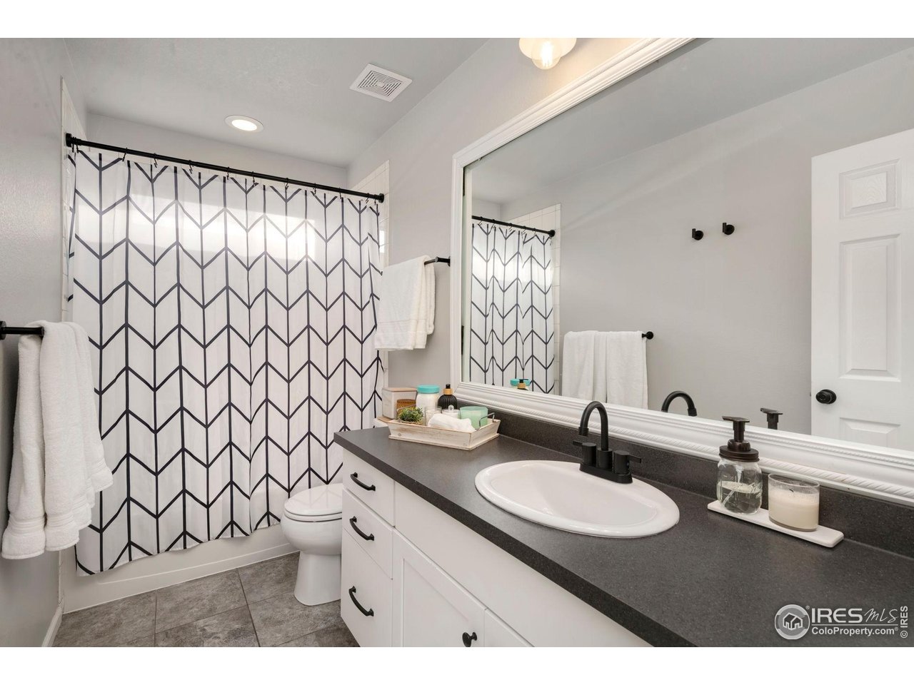 6420 Tuxedo Park Road Timnath, CO 80547 - Photo 19 of 44 a bathroom with a sink and a mirror