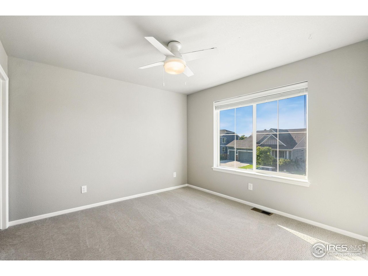 6420 Tuxedo Park Road Timnath, CO 80547 - Photo 21 of 44 an empty room with cabinet and windows