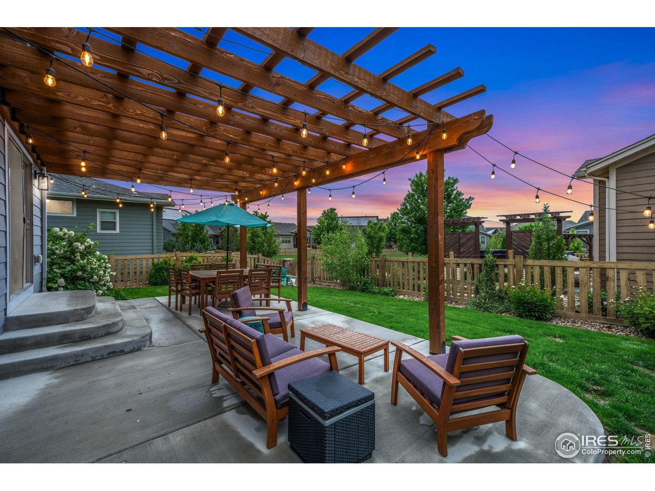 6420 Tuxedo Park Road Timnath, CO 80547 - Photo 28 of 44 a view of a patio with a table chairs and a backyard