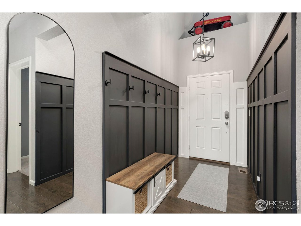 6420 Tuxedo Park Road Timnath, CO 80547 - Photo 3 of 44 a view of hallway with furniture and wooden floor