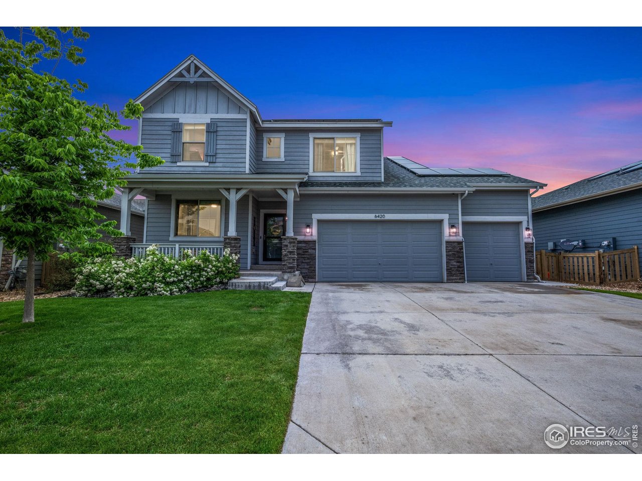 6420 Tuxedo Park Road Timnath, CO 80547 - Photo 35 of 44 a front view of a house with a yard and garage