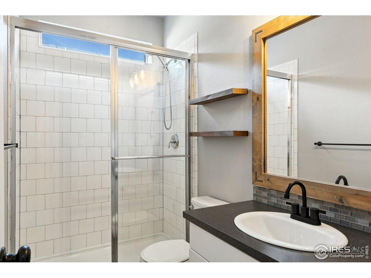 6420 Tuxedo Park Road Timnath, CO 80547 - Photo 42 of 44 a bathroom with a sink and a mirror