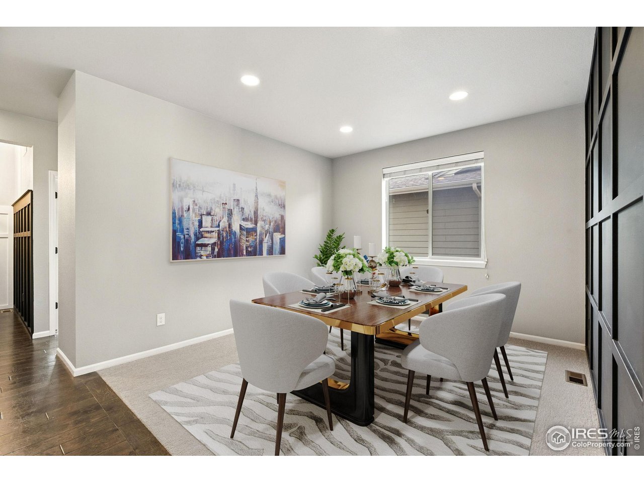 6420 Tuxedo Park Road Timnath, CO 80547 - Photo 10 of 44 a view of a dining room with furniture and wooden floor