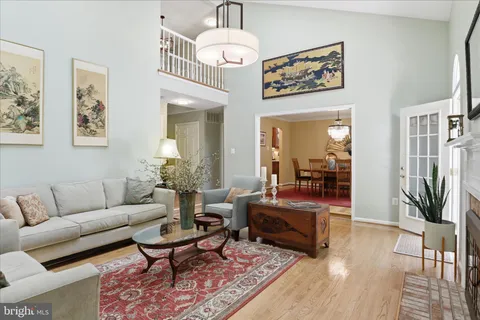 a living room with furniture a chandelier and a rug