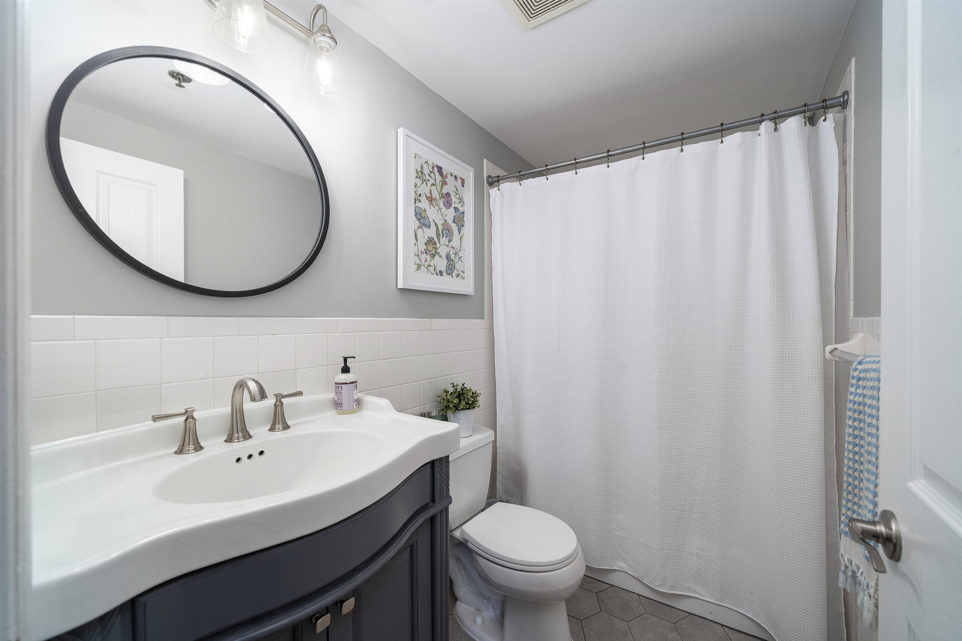 536 Grand Street, Unit 403 Hoboken, NJ 07030 - Photo 11 of 15 a bathroom with a toilet a sink and a mirror