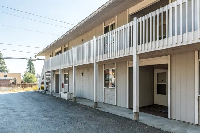 a view of a porch with wooden floor and fence
