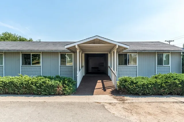 front view of a house with potted plants