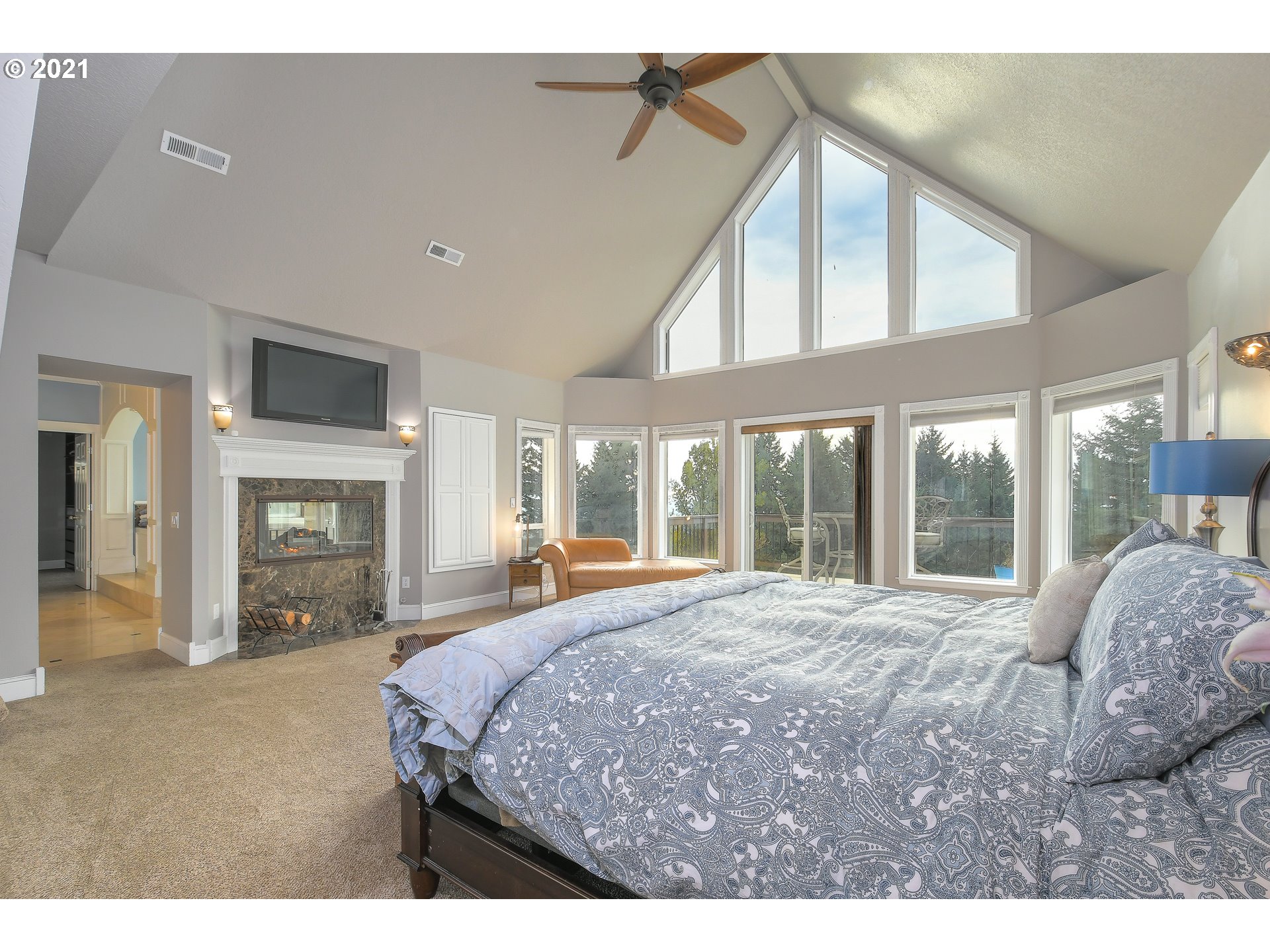 28400 Northeast Hancock Road Camas, WA 98607 - Photo 17 of 32 a bedroom with a large bed and a large window