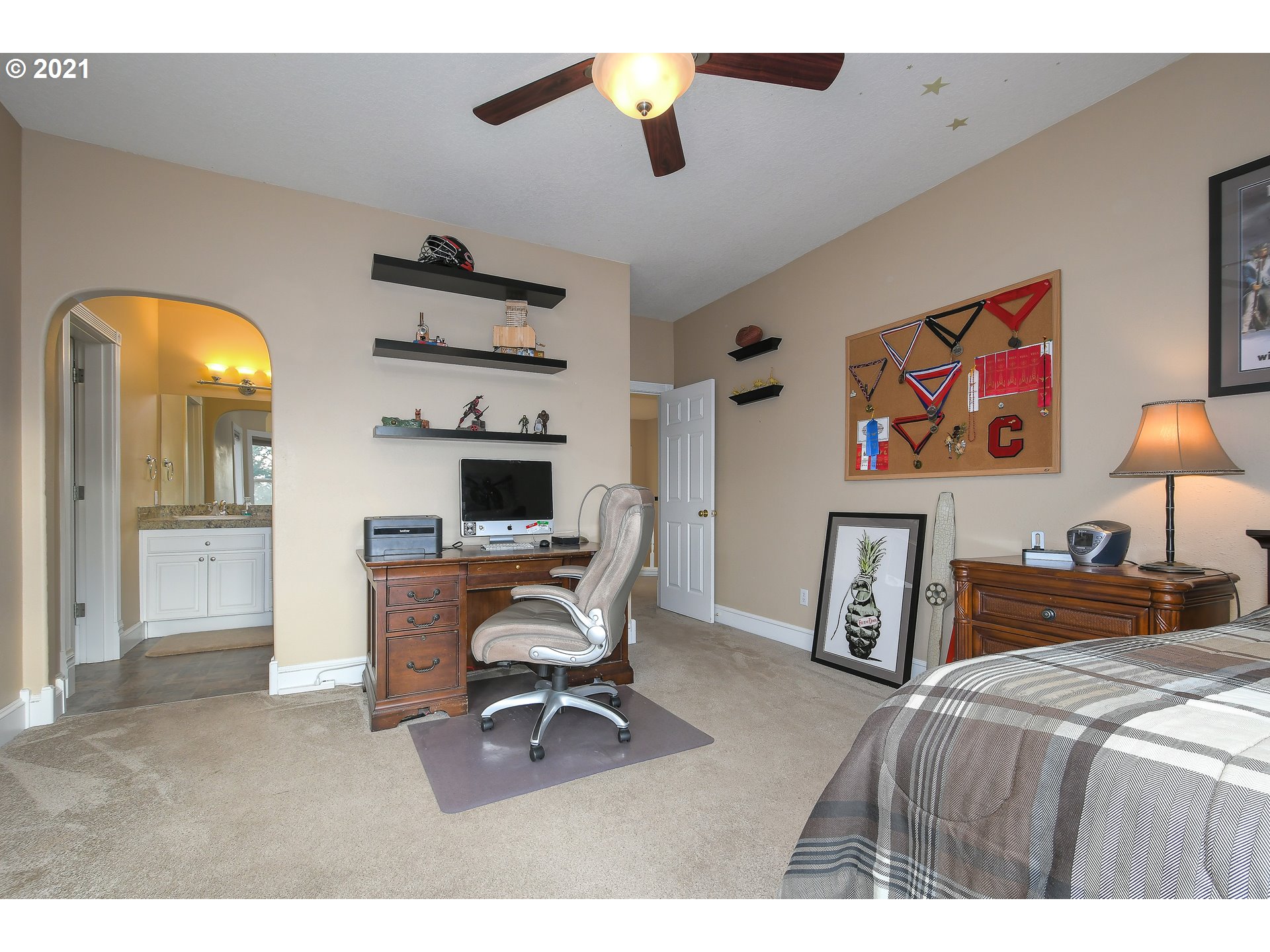 28400 Northeast Hancock Road Camas, WA 98607 - Photo 20 of 32 a bedroom with a bed and a chandelier