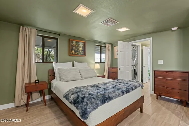 a bedroom with a large bed and a dresser