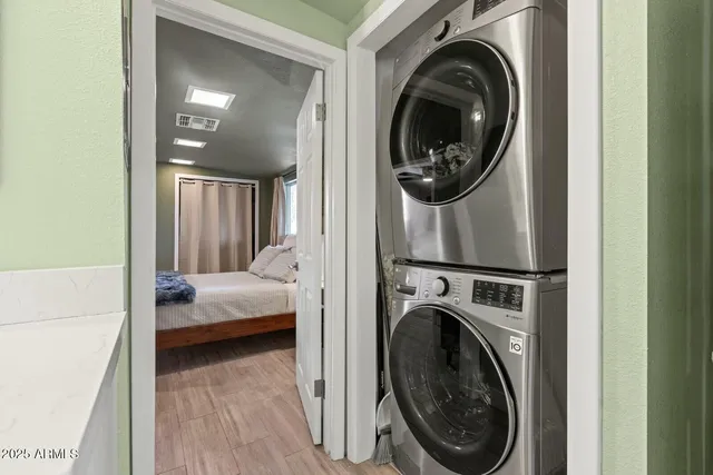 a view of a bedroom with washer and dryer