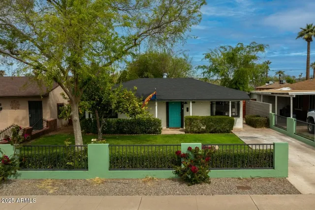 a front view of a house with a garden
