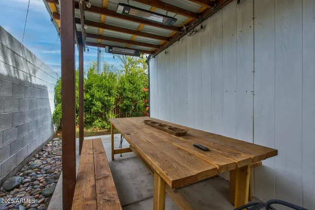 a view of a patio with table and chairs with wooden floor