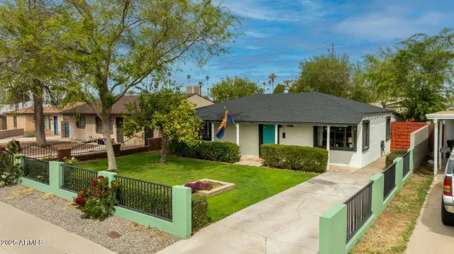 a front view of a house with a yard table and chairs