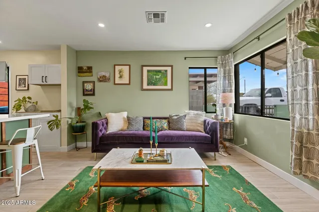 a living room with furniture a rug and a table