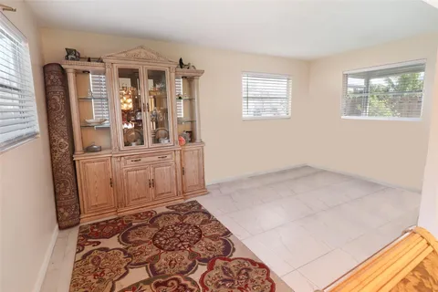 a view of a bedroom with window and furniture
