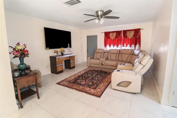 a living room with furniture and a flat screen tv