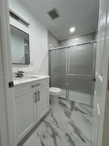 a view of kitchen with furniture and a refrigerator