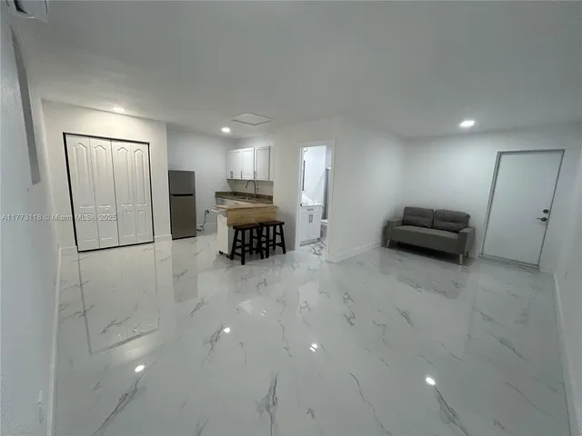 a room with a couch and a view of bathroom