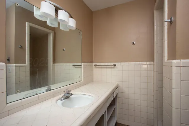 a bathroom with a sink and a mirror