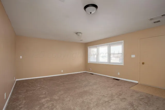 an empty room with a empty space and windows