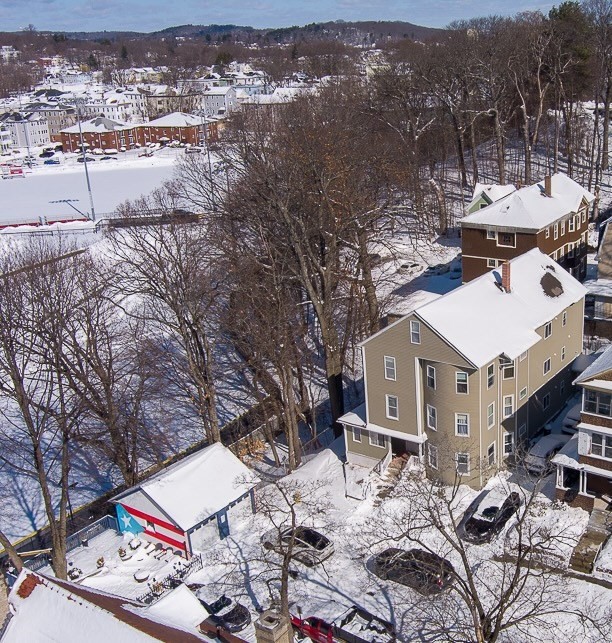an aerial view of a house with yard and mountain view in back