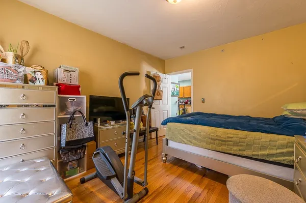 a bedroom with a bed and gym equipment