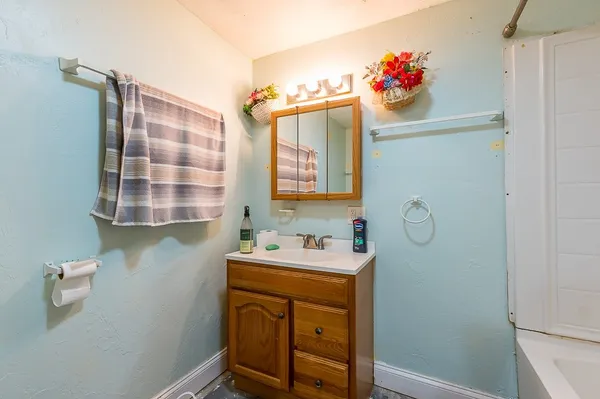 a bathroom with a sink mirror and vanity