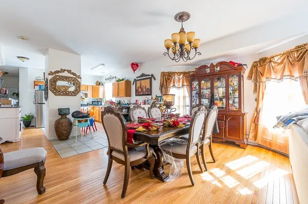 a view of a dining room with furniture and chandelier