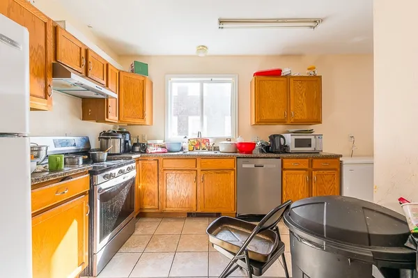 a kitchen with stainless steel appliances granite countertop a sink and cabinets