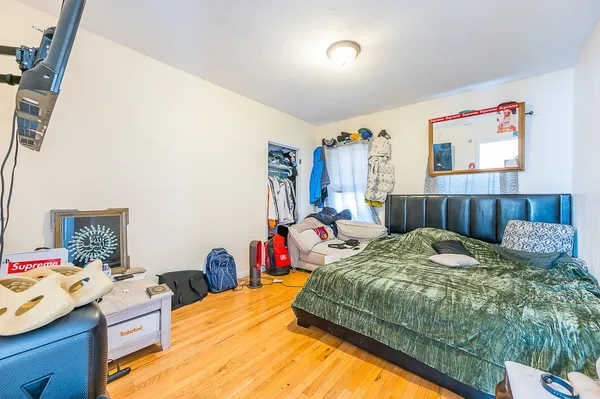 a bed sitting in a bedroom next to a window