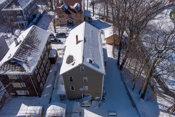 an aerial view of a house with a yard