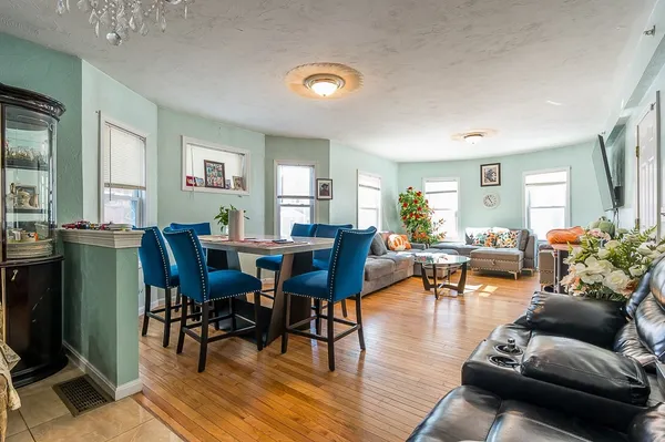 a living room with furniture and wooden floor