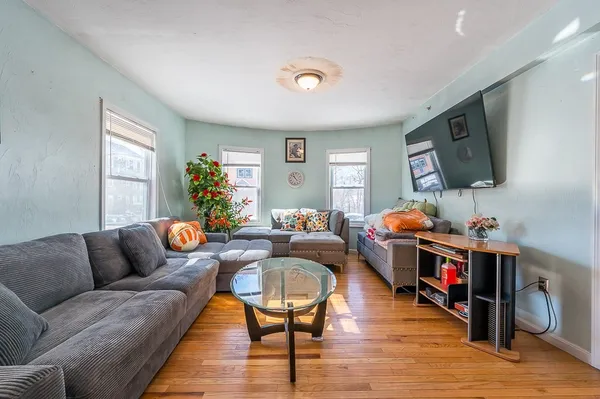 a living room with furniture and a flat screen tv