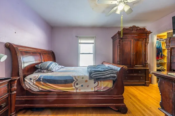 a bedroom with a bed and a chandelier