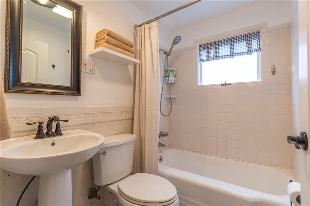 14 John Street Carnegie, PA 15106 - Photo 14 of 41 a bathroom with a sink a mirror bathtub and toilet