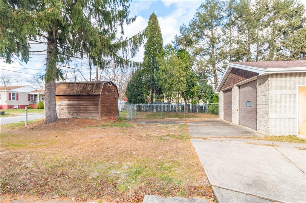 14 John Street Carnegie, PA 15106 - Photo 28 of 41 a front view of a house with a yard and garage