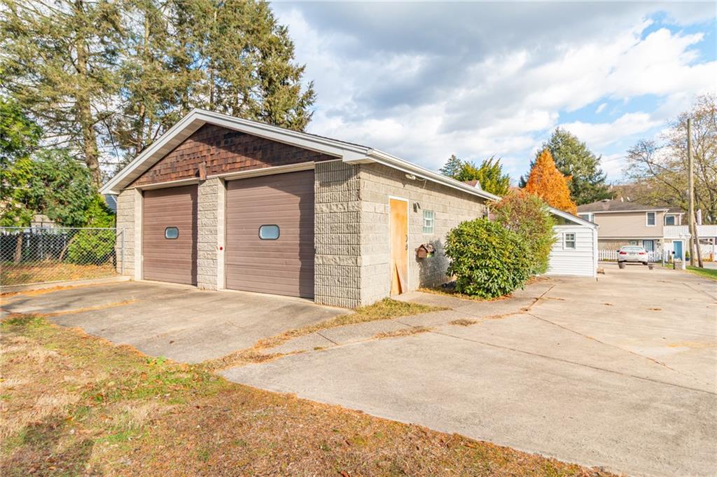14 John Street Carnegie, PA 15106 - Photo 32 of 41 a front view of a house with a yard and garage
