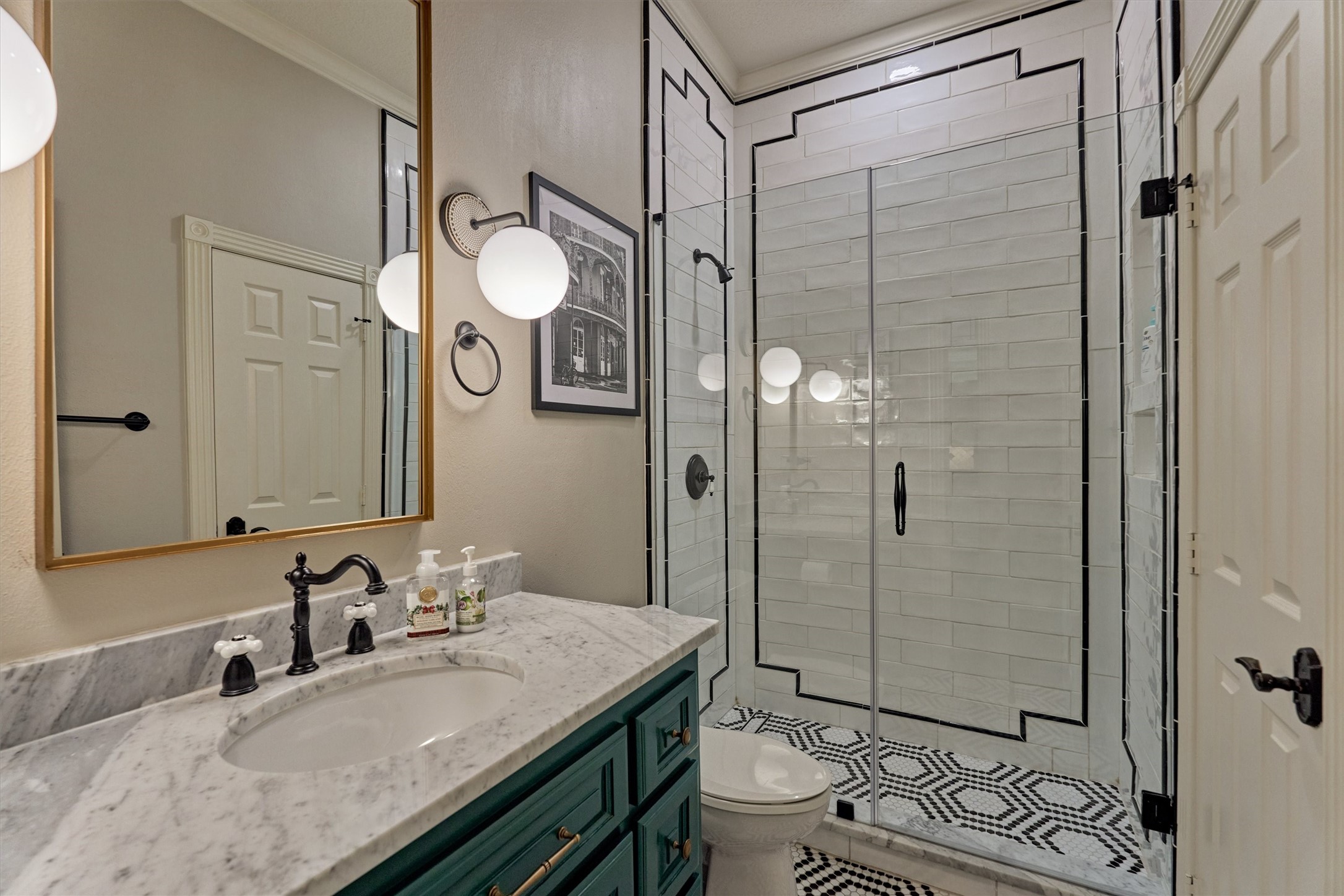 18 Treevine Court The Woodlands, TX 77381 - Photo 26 of 50 Full bathroom with a walk-in shower and hallway access, conveniently serving the first-floor guest suite and visitors alike.