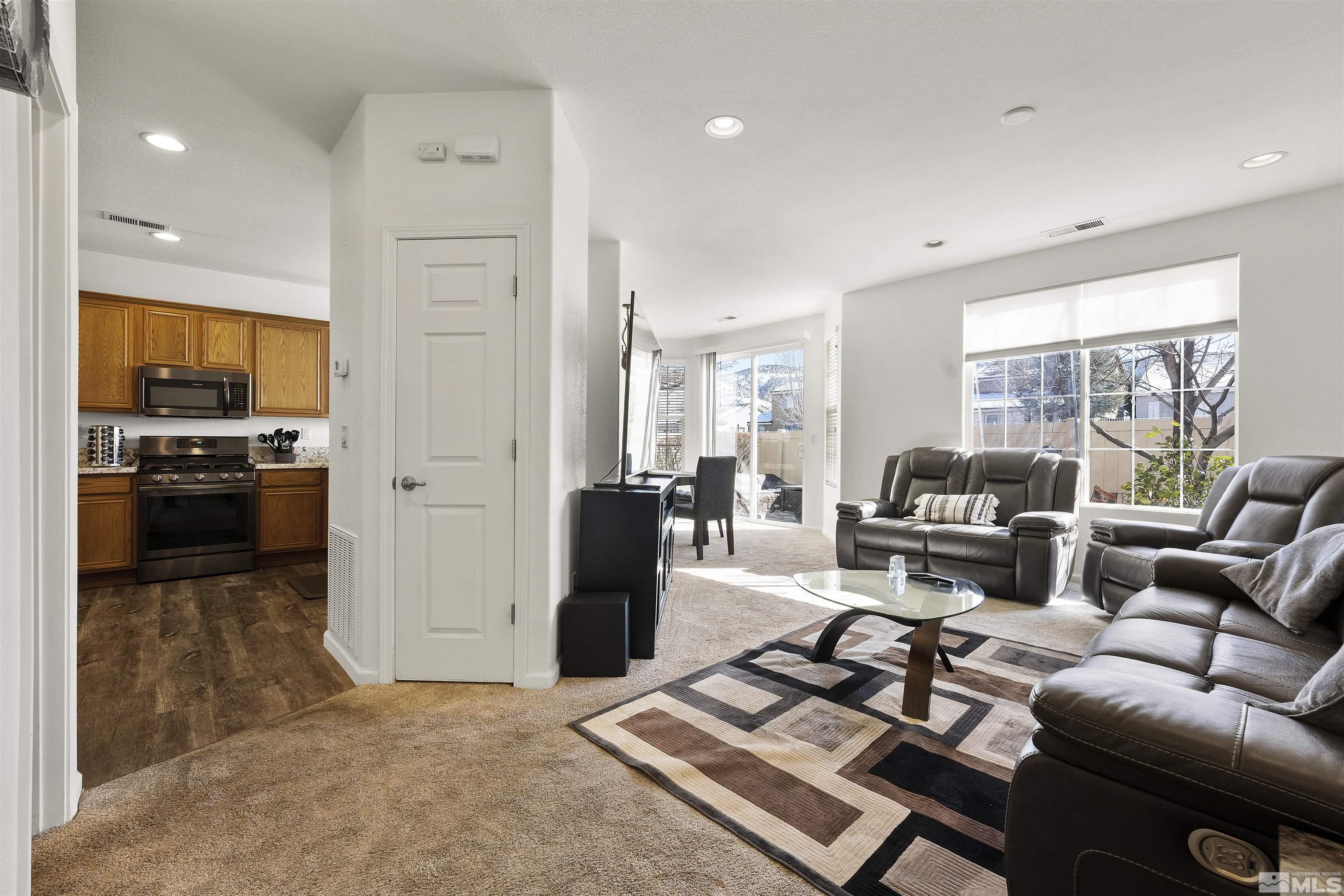 11022 Colton Drive Reno, NV 89521 - Photo 3 of 26 a living room with furniture and a open kitchen view