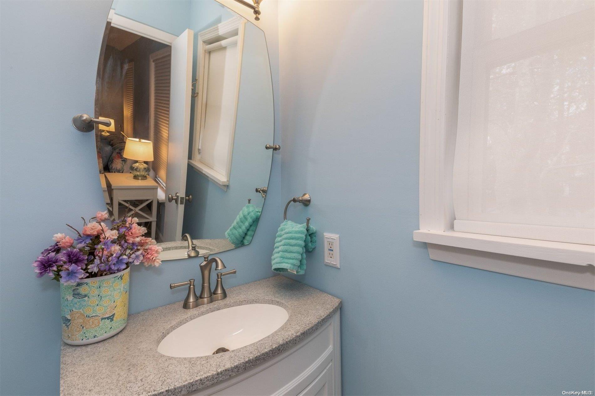 37 Halsey Road Remsenburg, NY 11960 - Photo 11 of 17 a bathroom with a granite countertop sink and a mirror