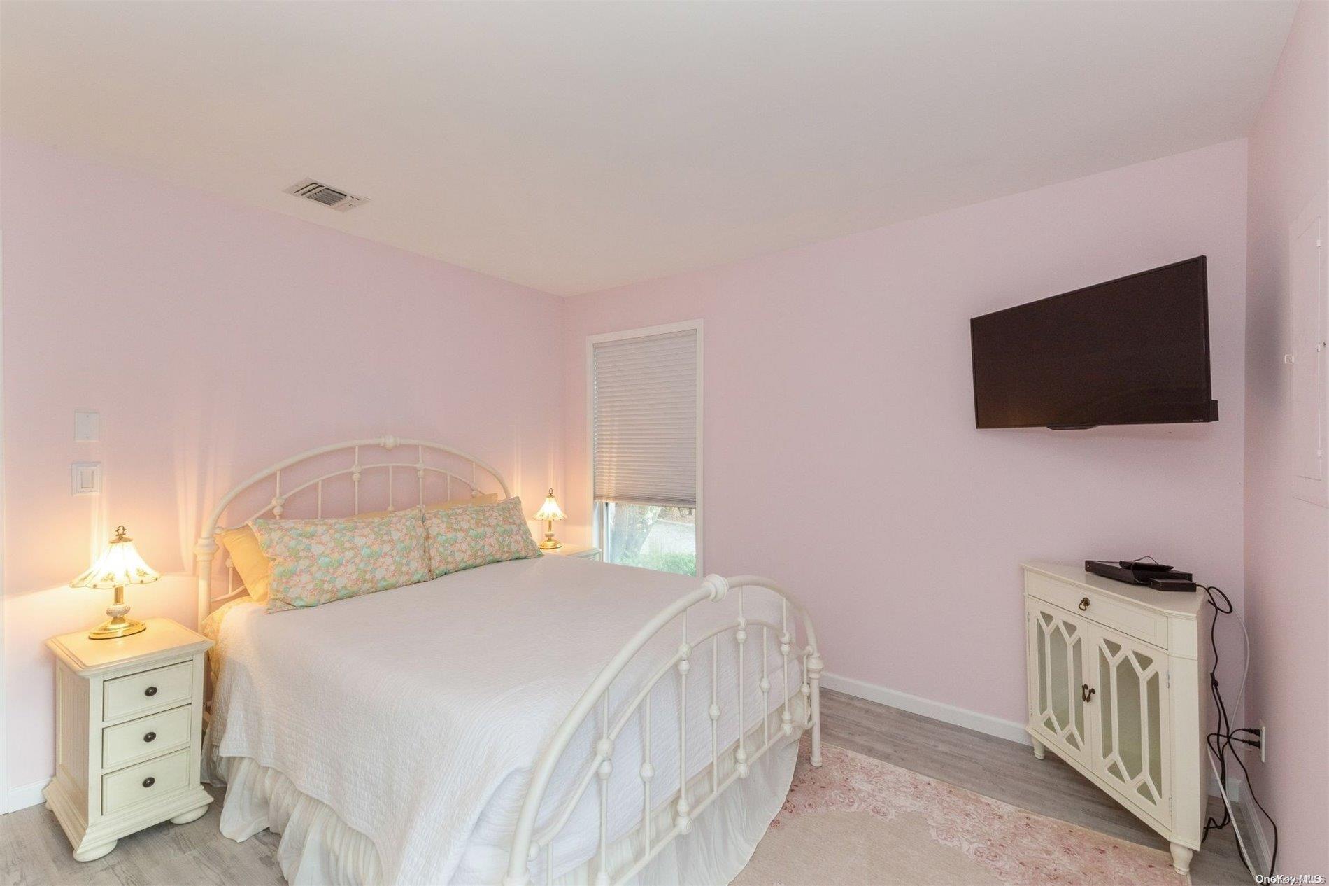 37 Halsey Road Remsenburg, NY 11960 - Photo 13 of 17 a bedroom with a bed and a flat screen tv