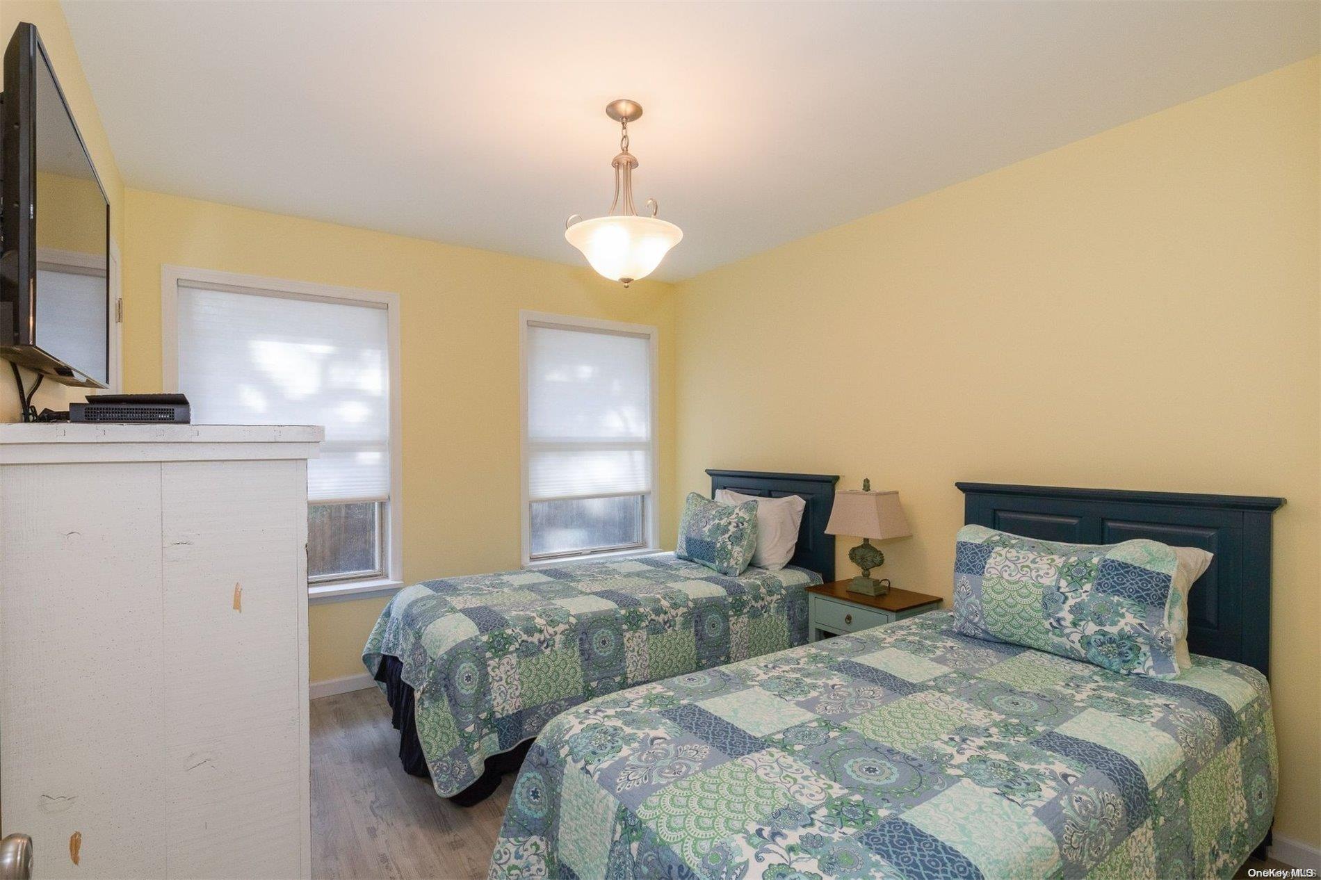 37 Halsey Road Remsenburg, NY 11960 - Photo 14 of 17 a bedroom with two beds and a flat screen tv